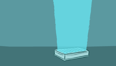 A scientist in blue goggles walks up to a counter and analyzes an item on a table